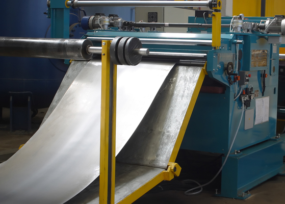 Close up view of sheet metal being cut at a fabrication facility
